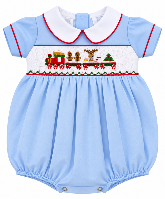 A light blue baby romper with a white Peter Pan collar, featuring a smocked Christmas train motif across the chest with red trim.